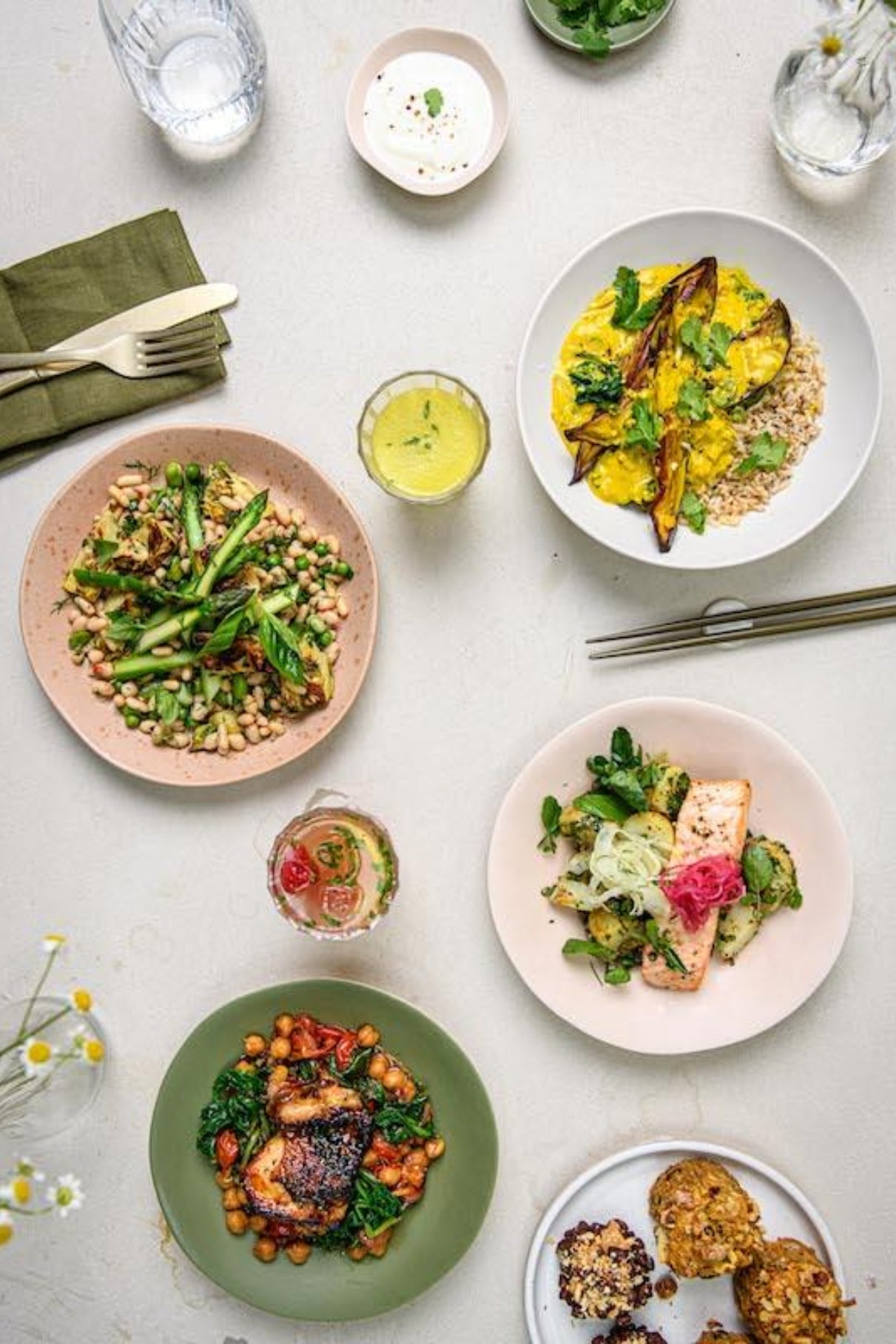A selection of well-presented pescatarian meals laid out on a table, including dishes such as salads and grain bowls.